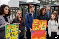 Swedish climate activist Greta Thunberg, second left, joins youths from Portugal during a demonstration outside the European Court of Human Rights, Apr. 9, 2024 in Strasbourg, eastern France.