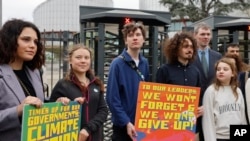 Swedish climate activist Greta Thunberg, second left, joins youths from Portugal during a demonstration outside the European Court of Human Rights Tuesday, April 9, 2024 in Strasbourg, eastern France.