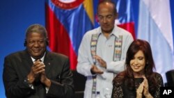 Argentina's President Cristina Fernandez, right, Antigua and Barbuda's Prime Minister Winston Baldwin, left, and Mexico's President Felipe Calderon, behind, applaud during the opening ceremony of the sixth Summit of the Americas in Cartagena, Colombia, Sa