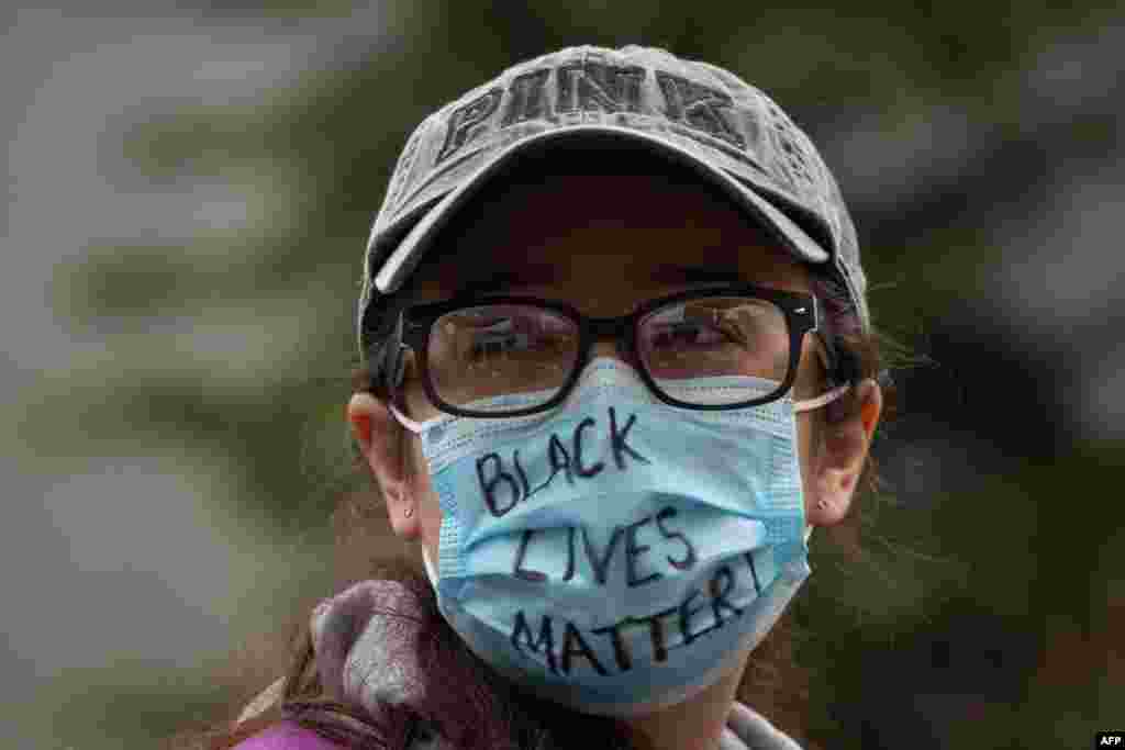 A demonstrator wears a Black Lives Matter mask during a gathering to protest the recent death of George Floyd on May 31, 2020, in Seattle, Washington.