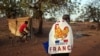 FILE - A man wears a French flag to show support for the French military intervention in Mali, in the capital, Bamako, Jan. 14, 2013. Coups in half a dozen former French colonies in Africa over the past three years are sparking soul searching about France's relations with Africa.