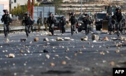 FILE - Israeli security forces clash with Palestinian protesters in the West Bank city of Ramallah, Dec. 11, 2017, as demonstrations continued to flare in the Middle East and elsewhere over U.S. President Donald Trump's declaration of Jerusalem as Israel's capital.