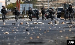 FILE - Israeli security forces clash with Palestinian protesters in the West Bank city of Ramallah, Dec. 11, 2017, as demonstrations continued to flare in the Middle East and elsewhere over U.S. President Donald Trump's declaration of Jerusalem as Israel's capital.