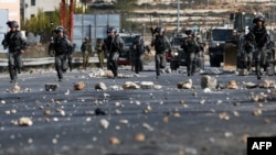 Israeli security forces clash with Palestinian protestors in the West Bank city of Ramallah on December 11, 2017 