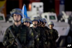 FILE - United Nations peacekeepers from Brazil stand at attention during the end of operations ceremony of the Brazilian battalion and engineering company, from the United Nations Stabilization Mission in Haiti, in Port-au-Prince, Aug. 31, 2017.