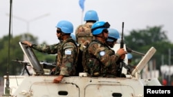 FILE - Peacekeepers serving in the United Nations Organization Stabilization Mission in the Democratic Republic of the Congo (MONUSCO) patrol in their armored personnel carrier, Dec. 20, 2016.