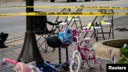 FILE: A child's bike is left behind after a mass shooting at a Fourth of July parade route in the wealthy Chicago suburb of Highland Park, Illinois, U.S. 5.4.2022