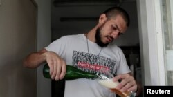 Francisco Lopez serves craft beer at Cerveza Caleta brewery in Caracas, Venezuela, September 13, 2017. 