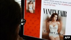 FILE - A journalist looks at Vanity Fair's Twitter site with the tweet about Caitlyn Jenner, the transgender Olympic champion formerly known as Bruce, June 1, 2015. 