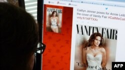 FILE - A journalist looks at Vanity Fair's Twitter site with the Tweet about Caitlyn Jenner, the transgender Olympic champion formerly known as Bruce, featured on the July 2015 cover of the magazine.