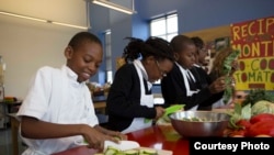 Students at Philip’s Academy harvest seasonal ingredients from their rooftop garden to create “seed-to-table” lunch meals. (Credit: Frank Mentesana)