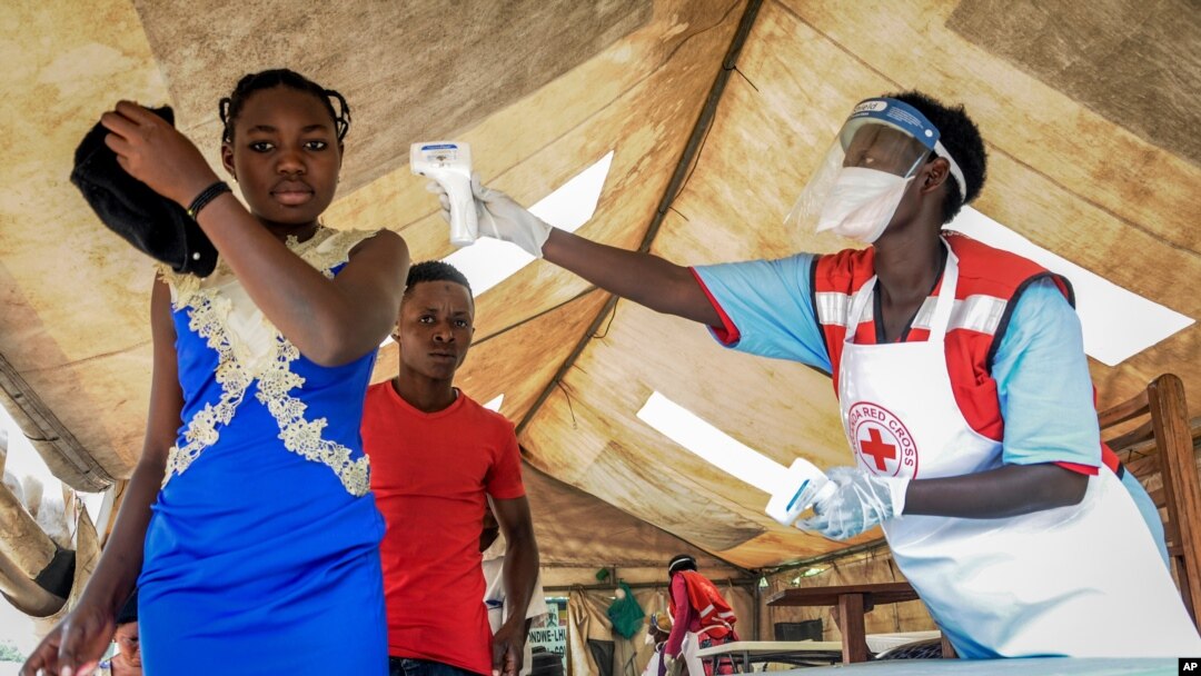 People coming from Congo have their temperature measured to screen for symptoms of Ebola, at the Mpondwe border crossing with Congo, in western Uganda, June 14, 2019.