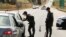 Israeli security force members stop a car as part of search efforts to capture six Palestinian men who escaped from Gilboa prison earlier this week, by the village of Muqeibila near the entrance to the Israeli-occupied West Bank, September 9, 2021.