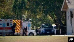 First responders work at the rear of the First Baptist Church of Sutherland Springs in response to a fatal shooting, Nov. 5, 2017, in Sutherland Springs, Texas.