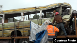 The mangled Lucky Vincent school bus is being hauled away after plunging into a ravine on May 6, 2017. The accident killed 35 people, mostly schoolchildren. (Courtesy - Willy Lowry)