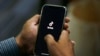 FILE - A man opens social media app TikTok on his cellphone in Islamabad, Pakistan, July 21, 2020. The government has blocked the video-sharing app several times in recent years over content moderation.