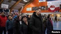 People queue to cast their votes at the polling station during general election in Nuuk, Greenland, March 11, 2025. 