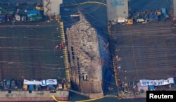 The sunken ferry Sewol is seen during its salvage operations at the sea off Jindo, South Korea, March 23, 2017.