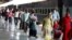 Migrant laborers, who arrived from Gujarat state on a train, rest before processding for their native villages in their home state of Uttar Pradesh in Prayagraj, India, May 6, 2020.