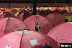 A woman surveys her surroundings as people take shelter at a stadium after a flooding in Golestan province, Iran, March 24, 2019.