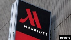 FILE - A sign advertises the New York Marriott Marquis in Manhattan. Marriott International bought Starwood Hotels and Resorts for $13.6 billion on Monday to create the world's biggest hotel chain, including three properties in Cuba. 