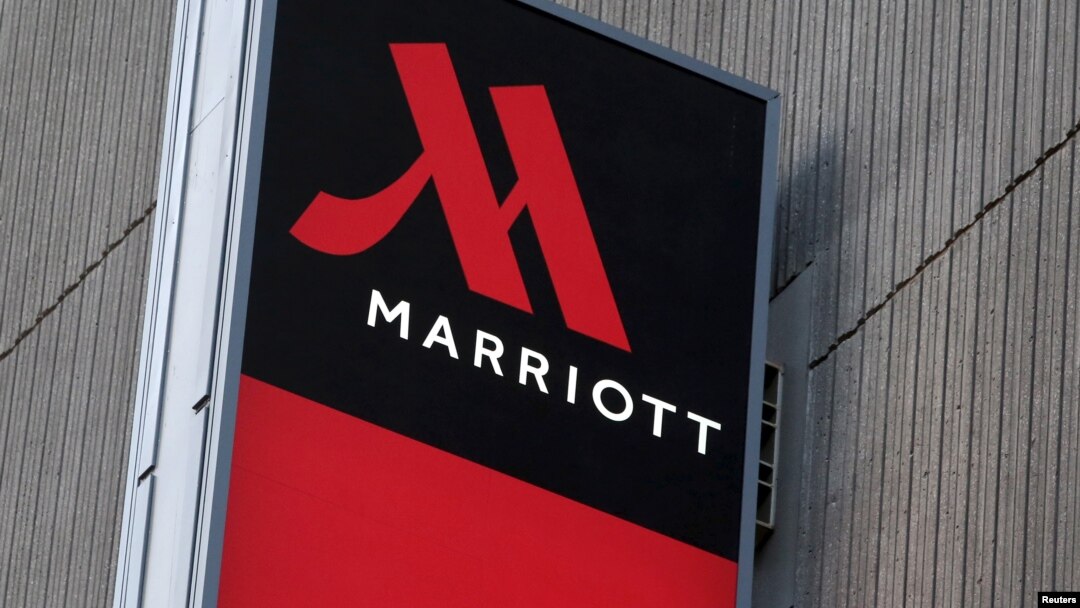 FILE - Signage for the New York Marriott Marquis is seen in Manhattan, New York, Nov. 16, 2015. Marriott International bought Starwood Hotels and Resorts for $13.6 billion on Monday to create the world's biggest hotel chain. 