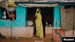 Child bride Krishna, 12, stands at a doorway into her compound in a village near Baran, in India's Rajasthan state, July 30 , 2011. Despite a law banning girls from marrying before they turn 18, the practice is deeply rooted in tradition and widely accepted in Indian society.