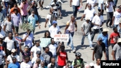 FILE - Demonstrators take part in a protest against Haiti's President Jovenel Moise, in Port-au-Prince, Haiti, Feb. 14, 2021.
