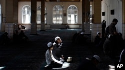 FILE - Kyrgyz men are seen during Friday prayers in a mosque in Osh, southern Kyrgyzstan.