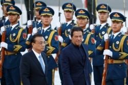 FILE - Pakistan's Prime Minister Imran Khan reviews the honor guard during a welcome ceremony with Chinese Premier Li Keqiang outside the Great Hall of the People in Beijing, China, Oct. 8, 2019.
