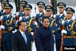 FILE - Pakistan's Prime Minister Imran Khan reviews the honor guard during a welcome ceremony with Chinese Premier Li Keqiang outside the Great Hall of the People in Beijing, China, Oct. 8, 2019.