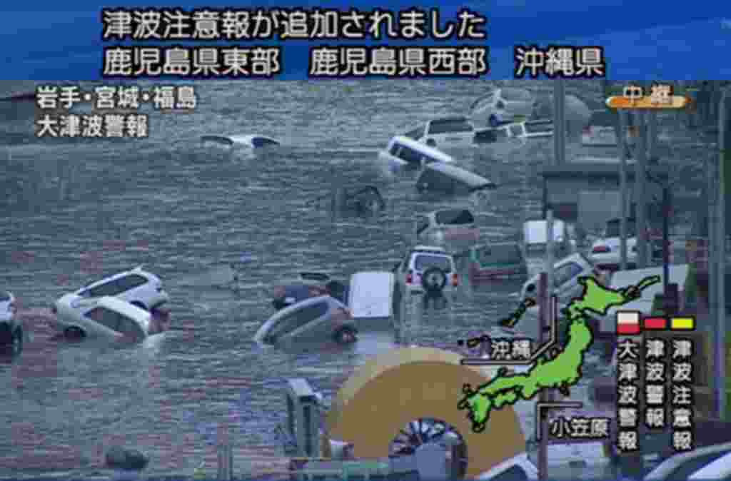 A screen grab taken from news footage by Japanese Government broadcaster NHK shows cars on a flooded street following an earthquake-triggered tsumani in Miyagi prefecture, March 11, 2011