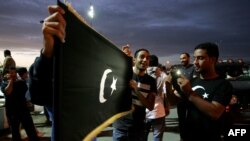 Libyan protesters hold the flag of the eastern Cyrenaica region during a demonstration calling for greater autonomy in the eastern city of Benghazi on November 2, 2012. AFP FILE 