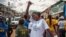 A woman celebrates with others as Sierra Leone is declared Ebola-free in Freetown, Sierra Leone, Nov. 7, 2015. 
