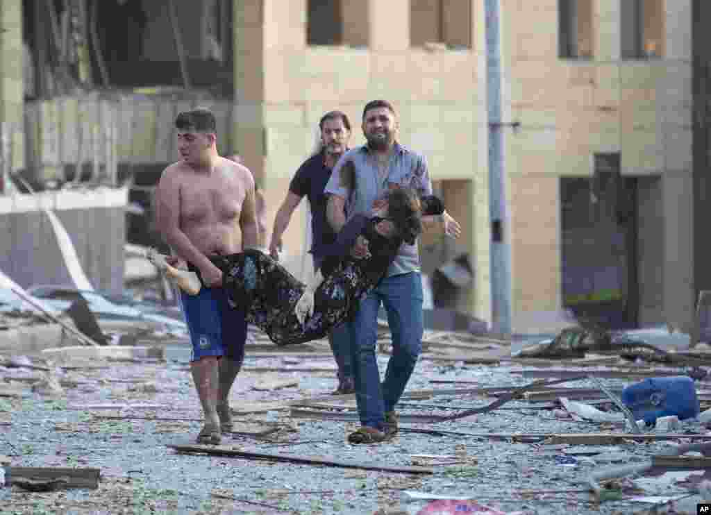 A wounder woman is evacuated after a massive explosion in Beirut, Lebanon, rippling through several parts of the city, causing widespread damage and very high number of injuries.