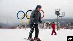 A visitor skis in front of the Olympic rings at the Rosa Khutor ski resort in Sochi, Russia, Jan. 12, 2018. Sochi hosted Olympic skiing in 2014, Russia.