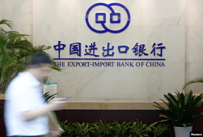 FILE - A man walks past the lobby of the Export-Import Bank of China (EXIM) headquarters in Beijing, June 13, 2017. “ExIm has become more risk-averse for new projects,” said Yunnan Chen, a researcher at the China Africa Research Initiative at SAIS.