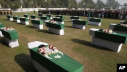 People offer funeral prayers of NATO airstrike attack victims in Peshawar, Pakistan, November 27, 2011.