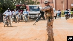 FILE - A soldier from Spain guards the European Union Training Mission (EUTM) camp in Koulikoro, Mali, Nov. 28, 2017. 