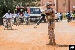 FILE - A soldier from Spain guards the European Union Training Mission (EUTM) camp in Koulikoro, Mali, Nov. 28, 2017.