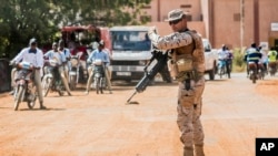 FILE - A soldier from Spain guards the European Union Training Mission (EUTM) camp in Koulikoro, Mali, November 28, 2017. 