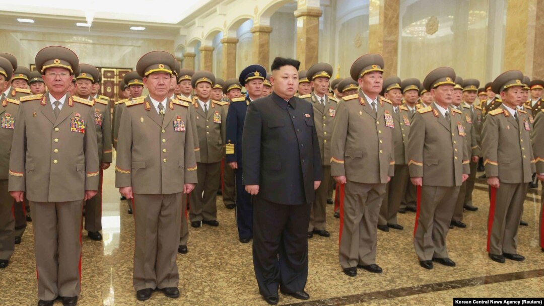North Korean leader Kim Jong Un, center, pays his respects to his grandfather and North Korea founder, Kim Il Sung, and his father, Kim Jong Il, at Kumsusan Palace of the Sun, Jan. 1, 2015.
