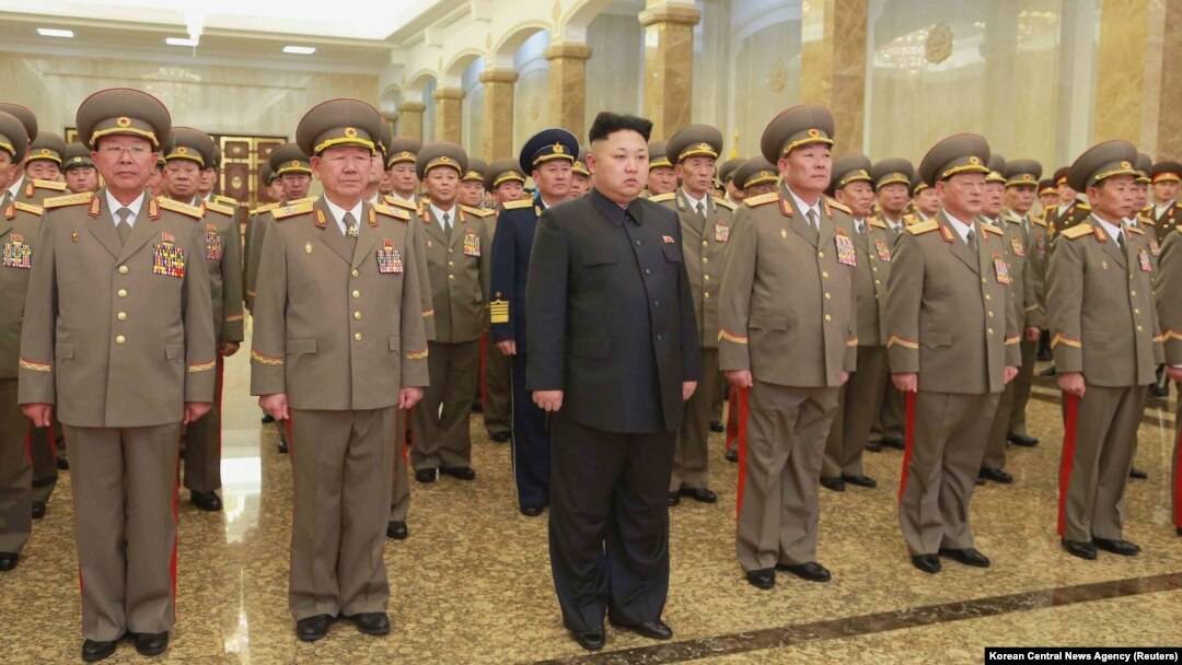 North Korean leader Kim Jong Un, center, pays his respects to his grandfather and North Korea founder, Kim Il Sung, and his father, Kim Jong Il, at Kumsusan Palace of the Sun, Jan. 1, 2015.