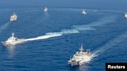 资料照：在有争议的尖阁诸岛（中国称钓鱼岛）附近的中国海警船与日本海岸警卫队船只。（2013年9月10日）