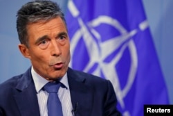 NATO Secretary General Anders Fogh Rasmussen speaks during an interview with Reuters at alliance headquarters in Brussels August 11, 2014.