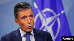 NATO Secretary General Anders Fogh Rasmussen speaks during an interview with Reuters at alliance headquarters in Brussels August 11, 2014.