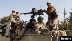 Houthi rebel fighters patrol a street in Sanaa, Yemen, Jan. 21, 2015. 