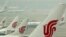 FILE- Air China planes are seen on the tarmac of the Beijing Capital International Airport, July 11, 2011. 