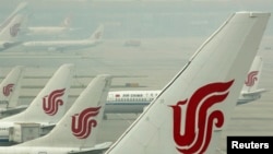 FILE - Air China planes are seen on the tarmac of the Beijing Capital International Airport, July 11, 2011. 