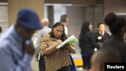 FILE - Malana Long fills out a job application during a job fair for the homeless at the Los Angeles Mission in the Skid Row area of Los Angeles, California, June 4, 2015. The number of people signing up for unemployment benefits in the United States fell to a 42-year low last week.